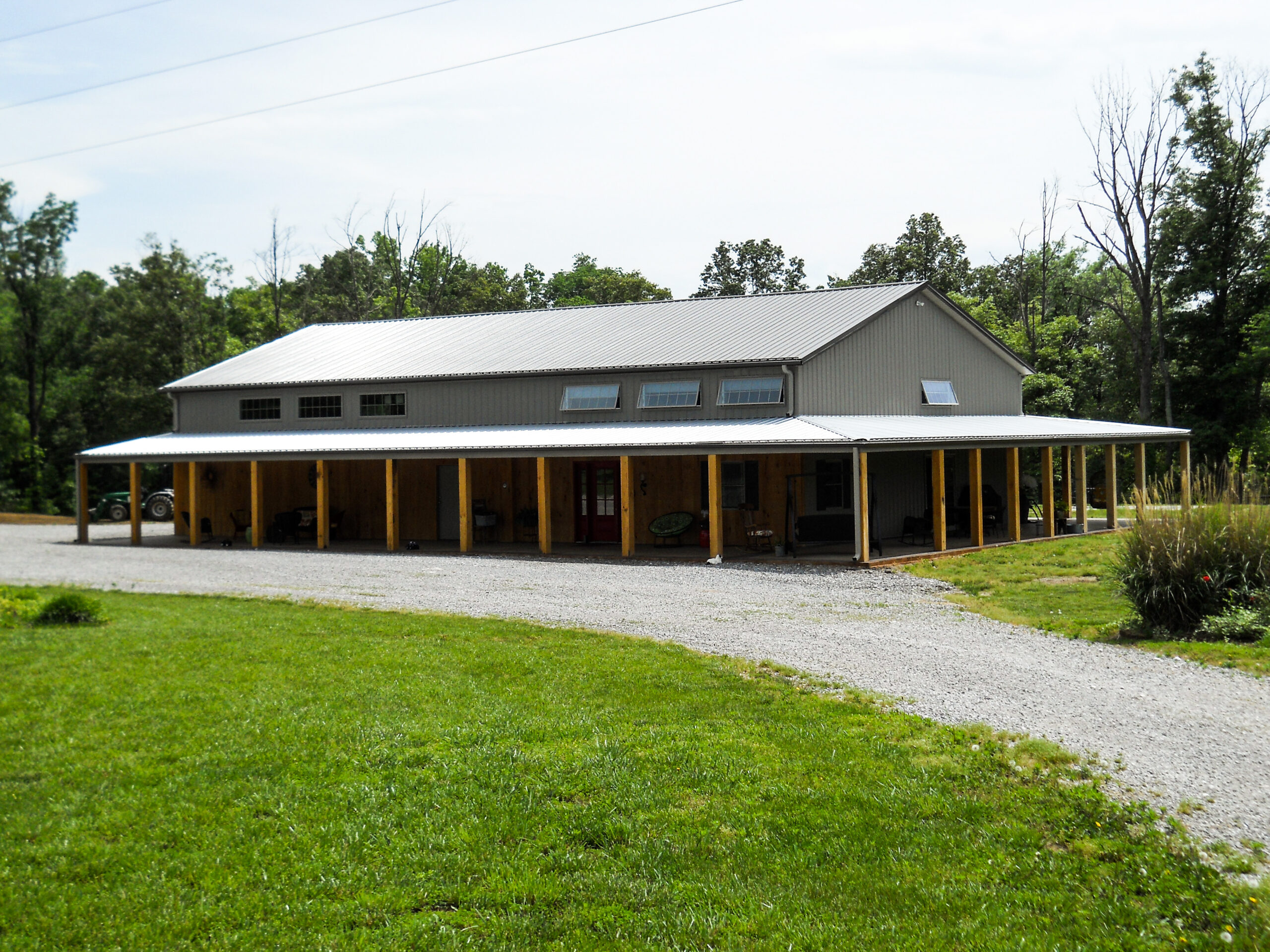 Gray barn style home with a wrap around porch in Marion, Illinois