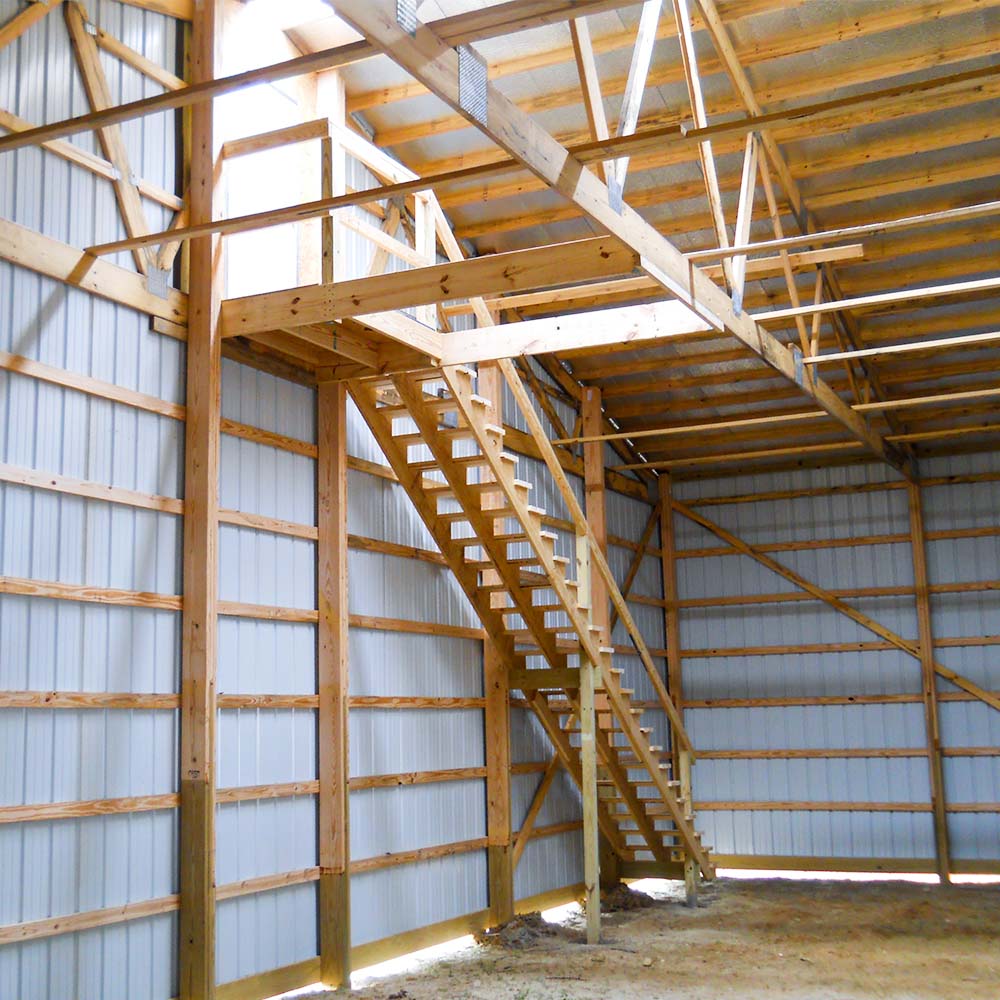 Interior of a metal structure with exposed post frames and staircase in Marion, Illinois