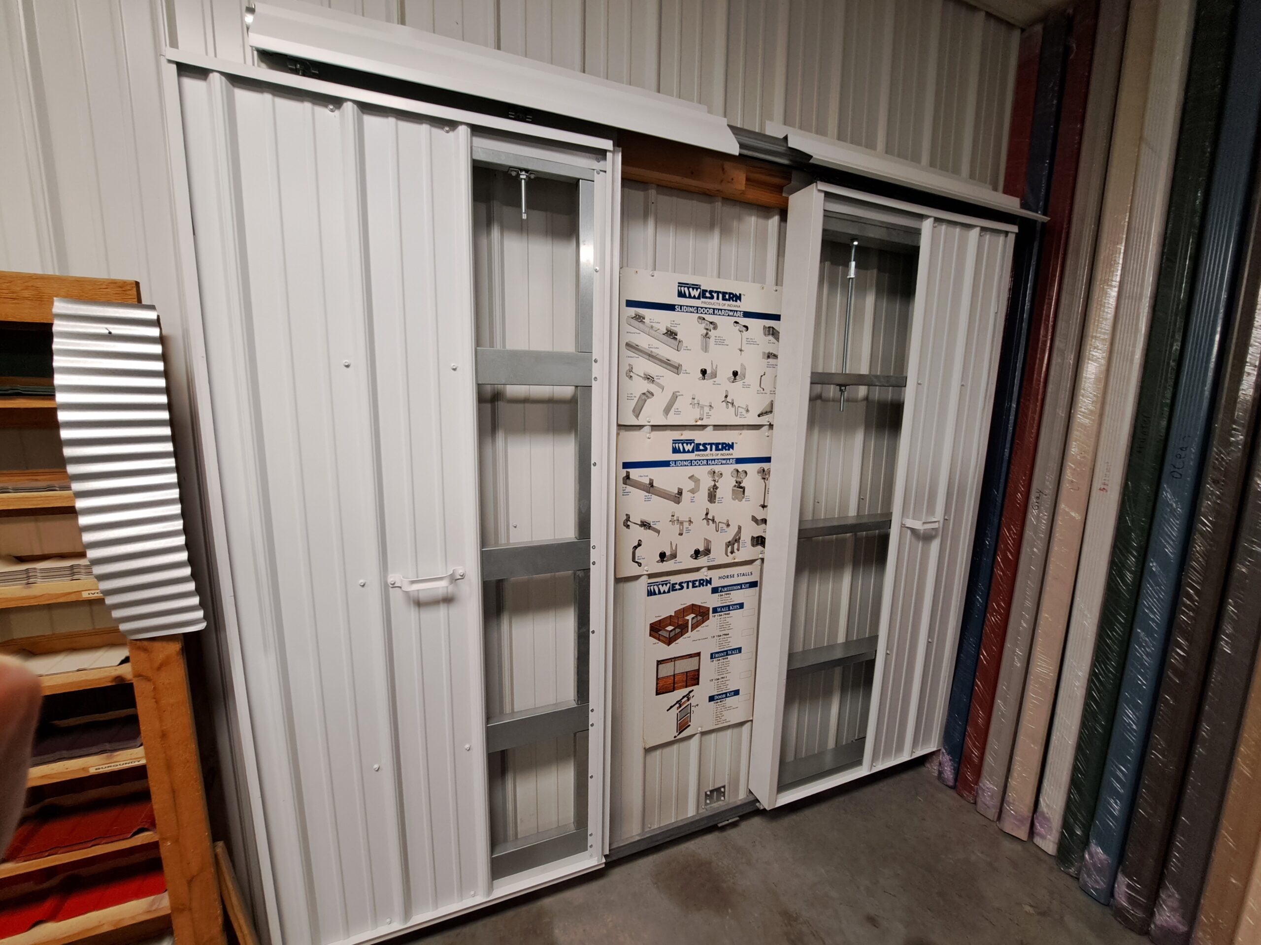 Sliding metal doors and metal samples on inside of Heartland Metal and Building Supplies showroom